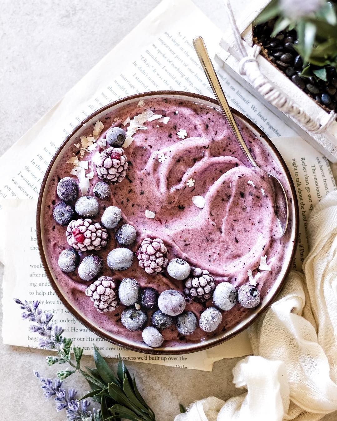 blueberry smoothie bowl â topped with frozen berries and coconut shreds ...