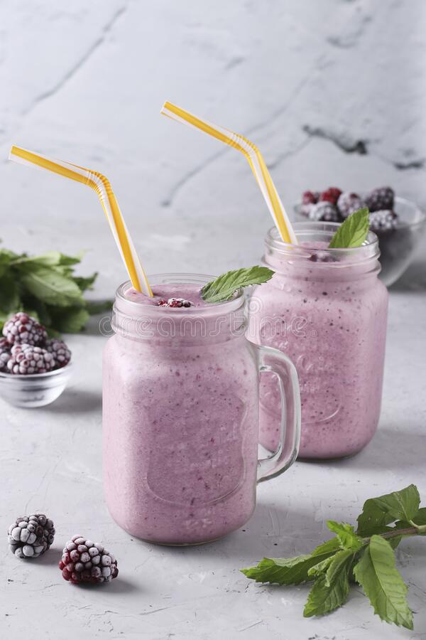 Homemade Smoothies With Frozen Blackberries In Glass Jars On Gray ...