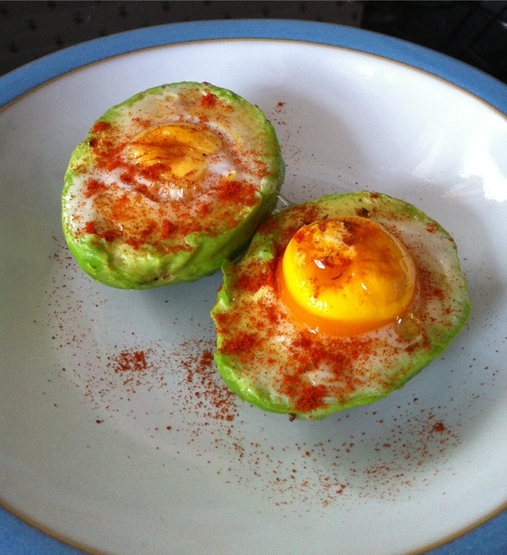 #snack eggs cooked in avocado topped with paprika &  banana ...